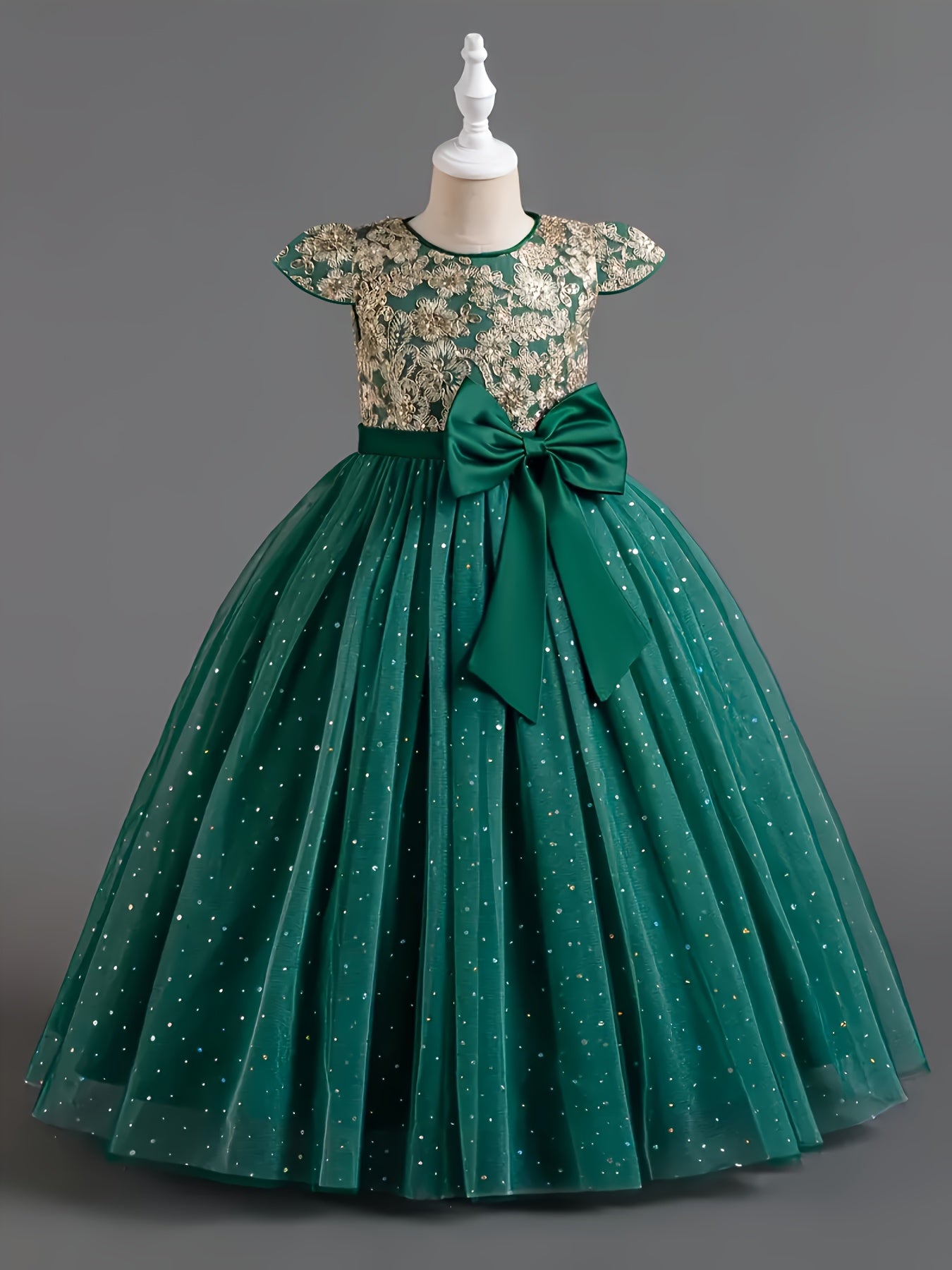 Girls floral wedding dress in green with a lace top and bow, perfect for special occasions