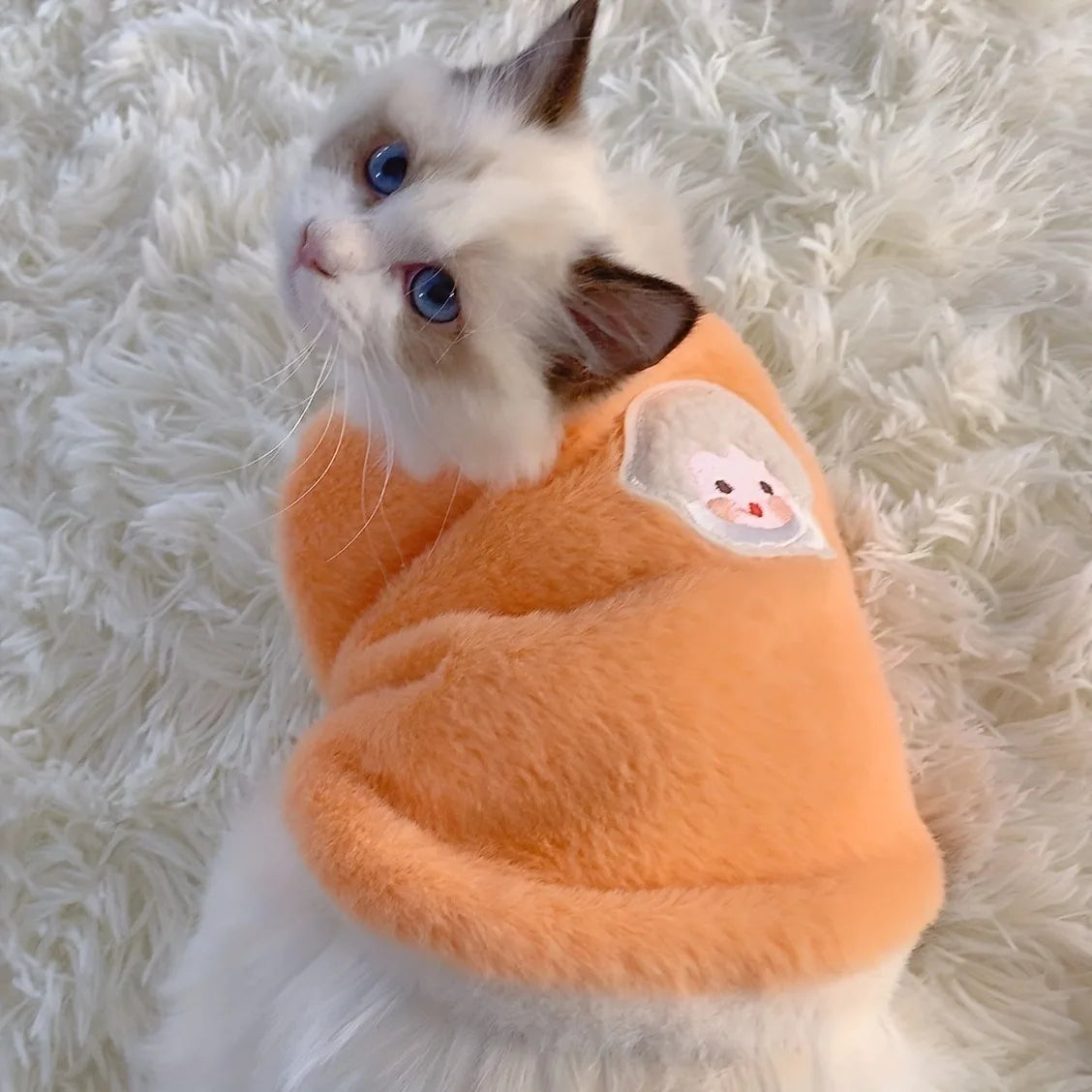 Soft fleece cat vest for winter in orange with cute animal patch for cozy indoor wear