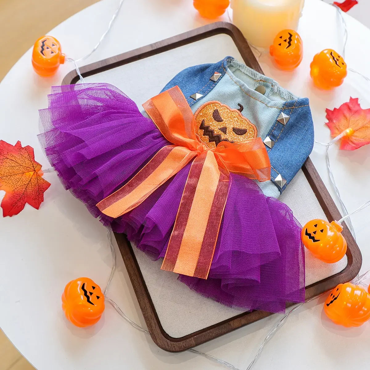 Cute Halloween pumpkin skirt for pets featuring purple tulle and an orange pumpkin bow