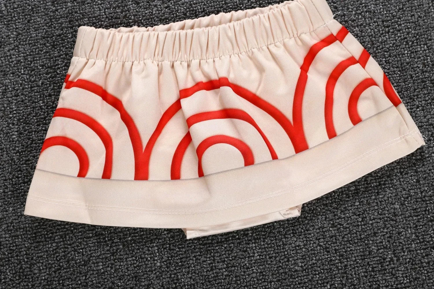 Moana costume for little girls featuring a playful skirt with red circular patterns