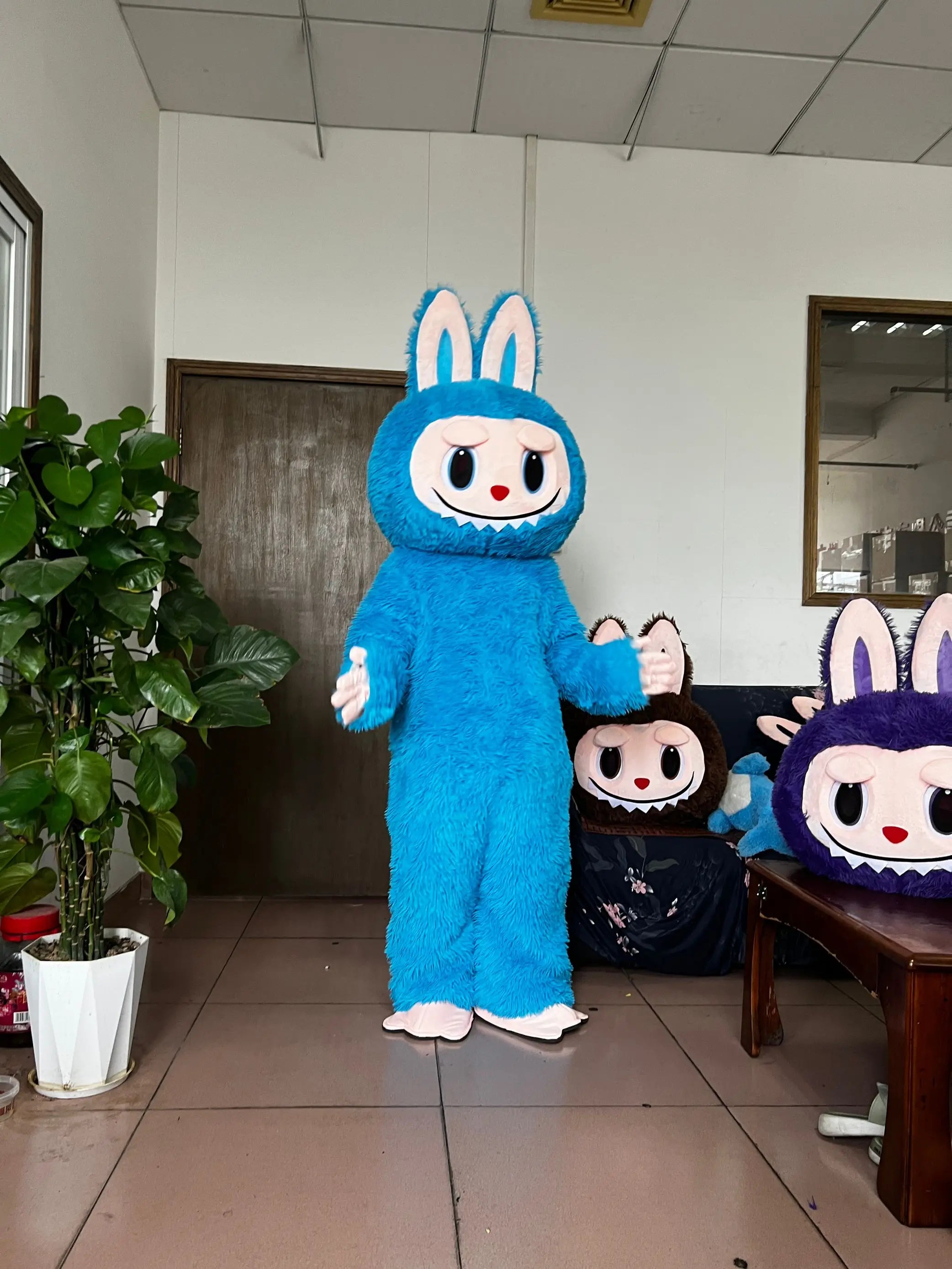 Blue plush bunny costume by Zoomies & Co with large ears and a friendly face for events and parties