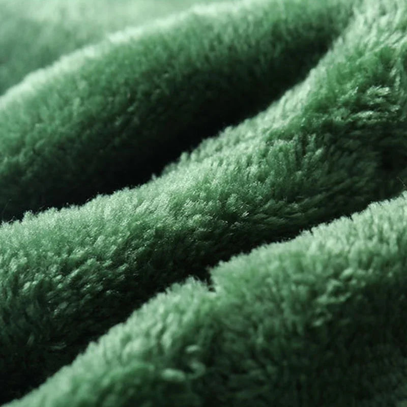 Soft green fabric close-up for a dinosaur dog costume hoodie by Zoomies & Co