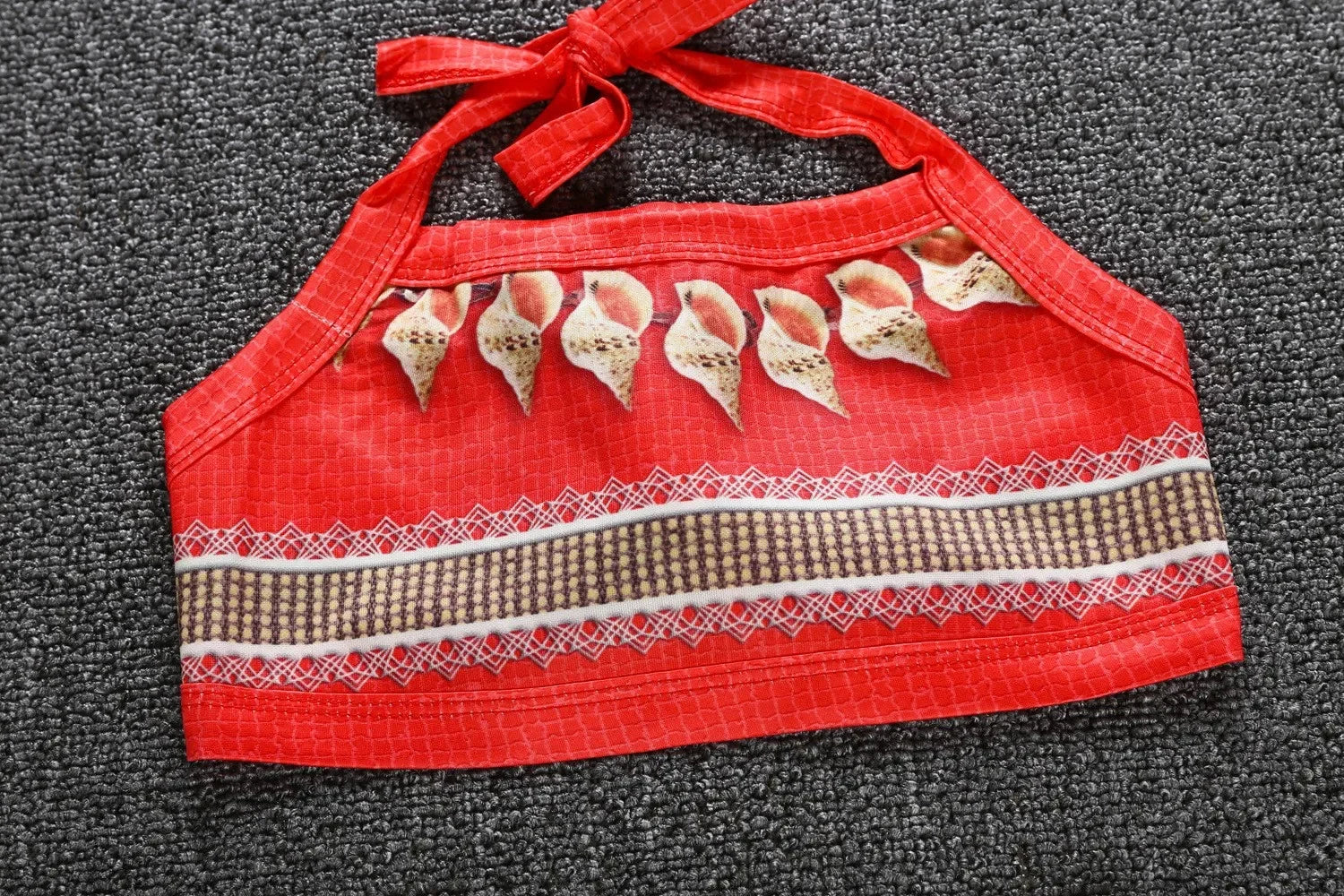 Moana costume for little girls featuring a vibrant red halter top with decorative seashell details