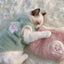 Cozy cat wearing a soft fleece cat vest for winter, resting on a fluffy surface