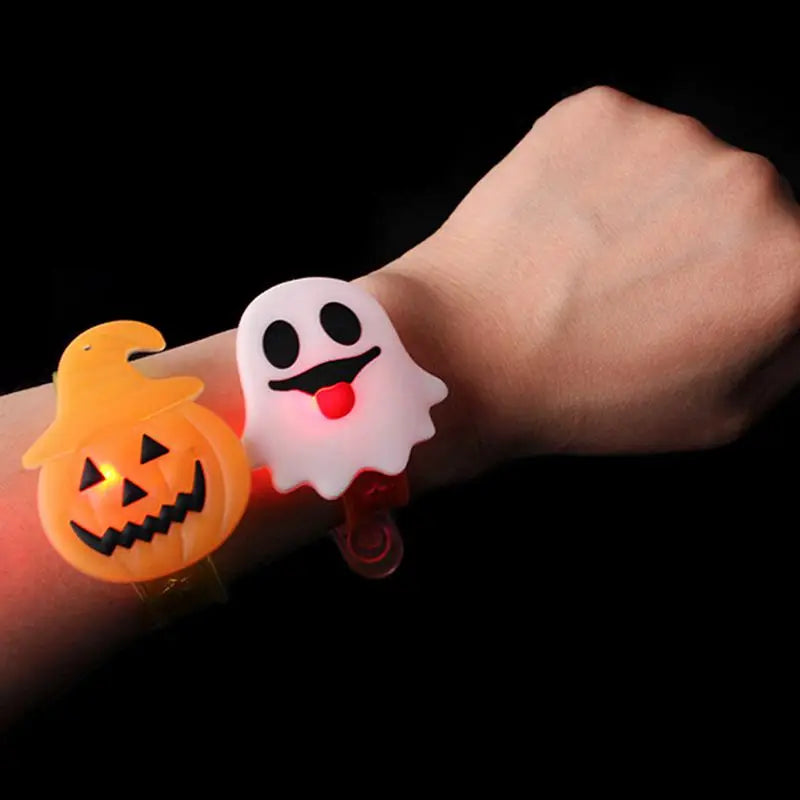 Glow-in-the-dark Halloween party bracelets and rings featuring a pumpkin and ghost design