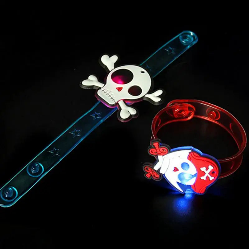 Glow-in-the-dark Halloween party bracelets and rings featuring skull and pirate designs