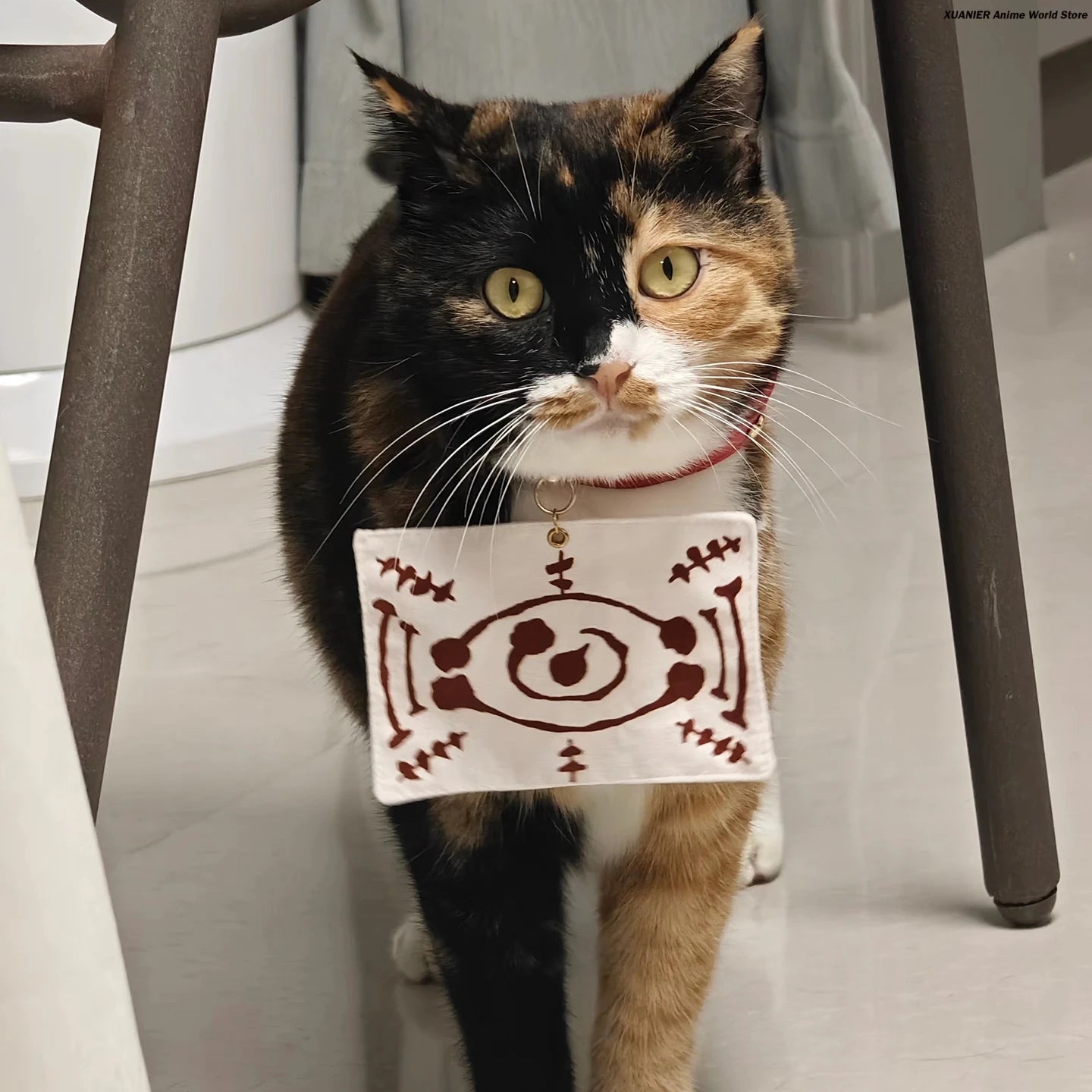 Calico cat wearing an anime cat costume for pets with a whimsical design around its neck
