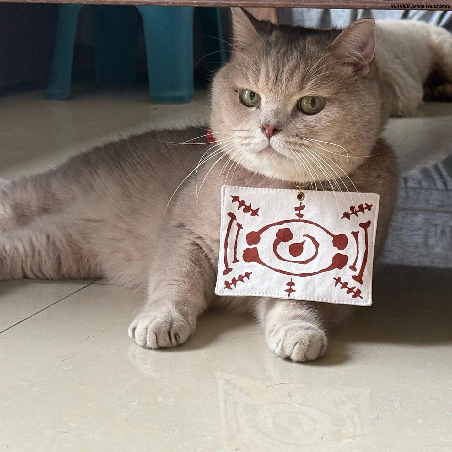 Cute cat wearing an anime cat costume for pets with a decorative collar tag