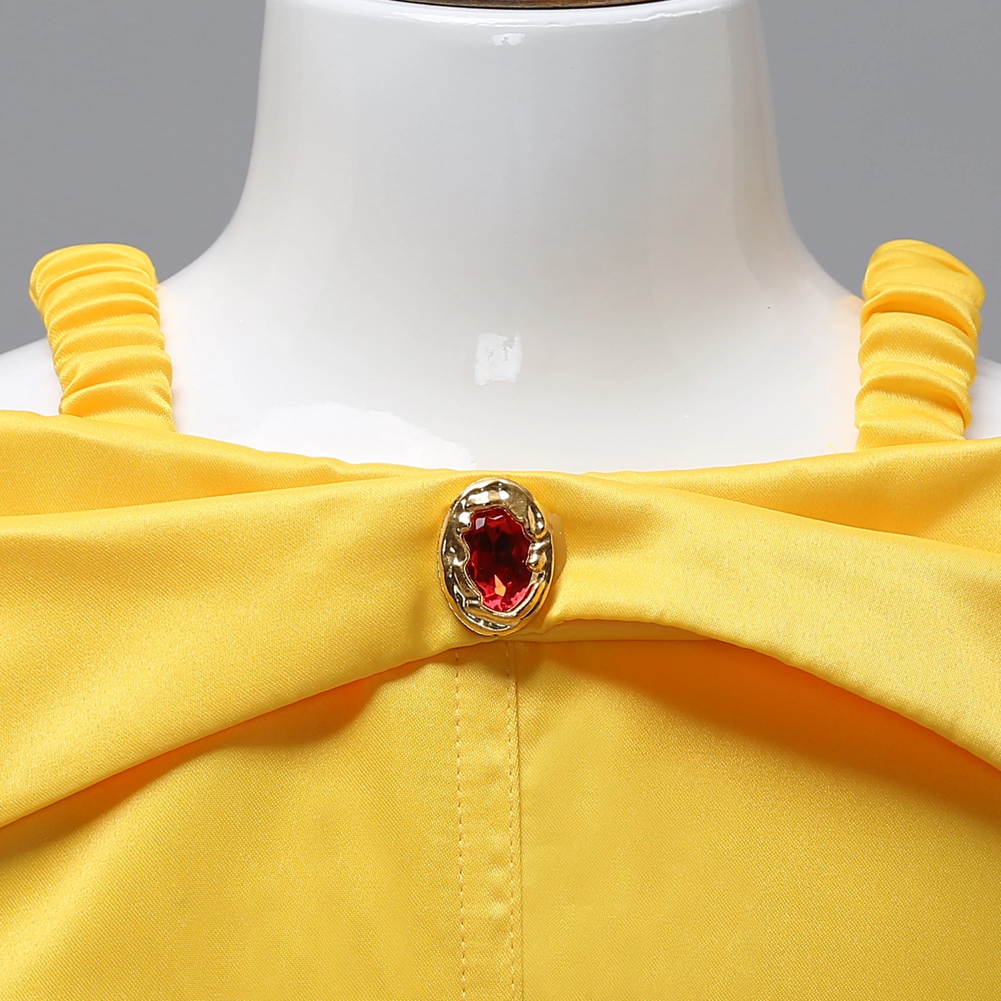 Beauty and the Beast girls costume with yellow fabric and red jewel detail on the neckline