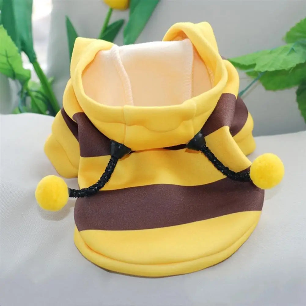 Yellow and brown bee costume for small dogs with a soft hood and playful pom-poms