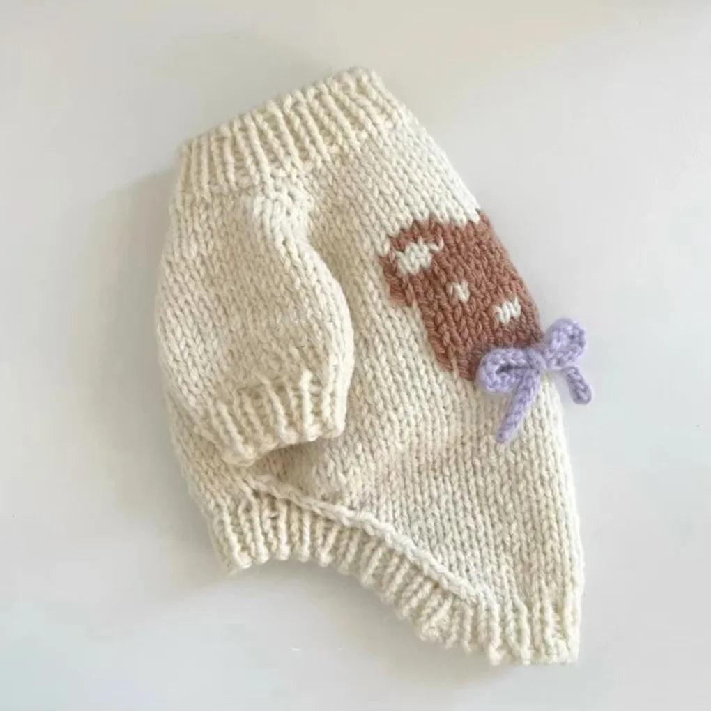 Beige knit dog sweater with bear design featuring a cute bear and purple bow detail