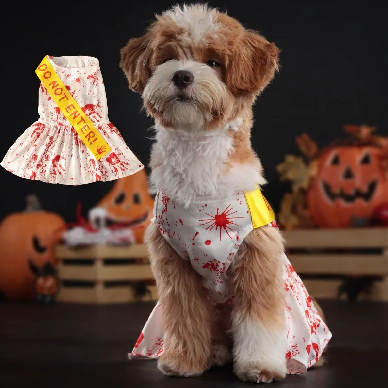 Cute dog wearing a blood splatter dog dress with a yellow sash for Halloween celebrations