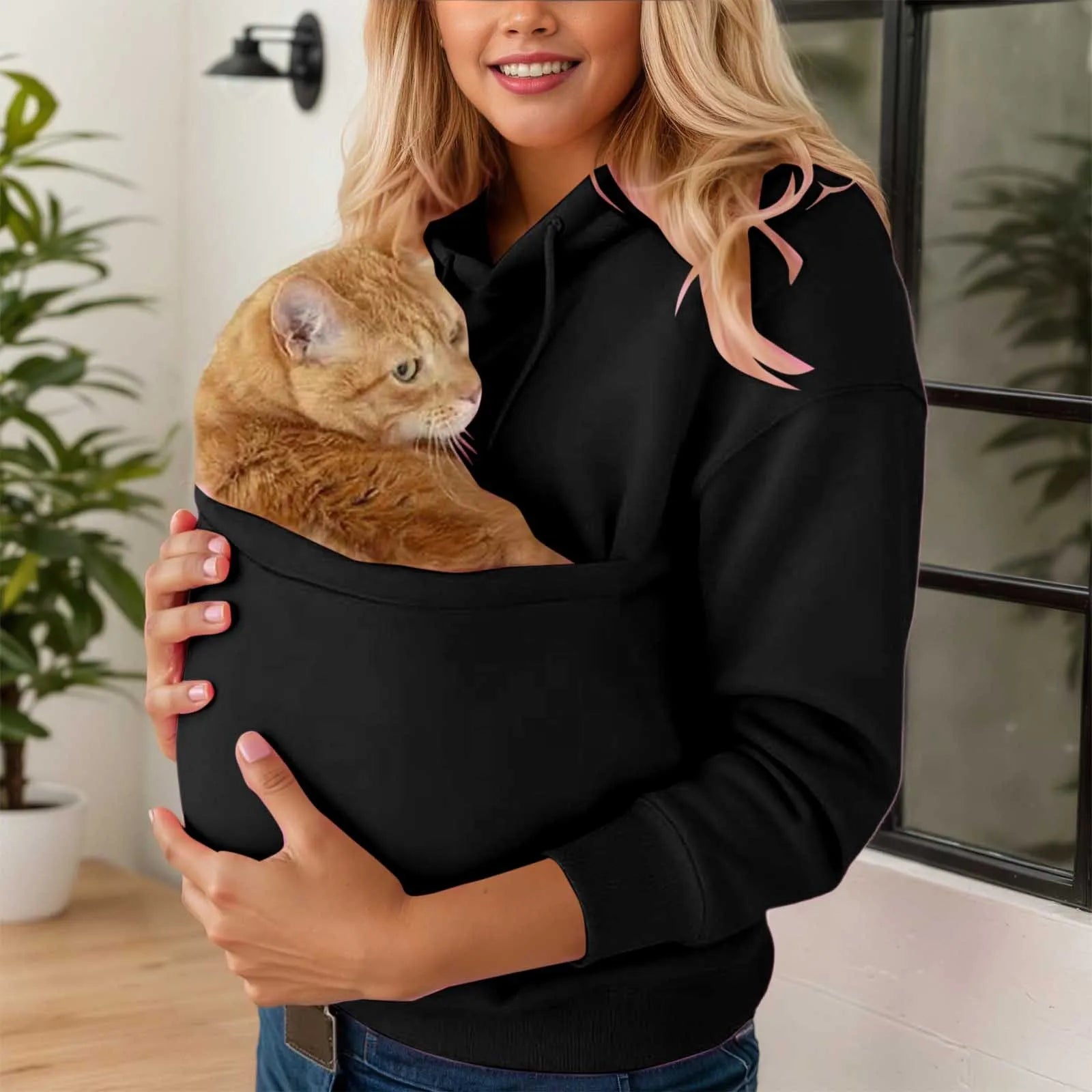 Cozy black cat carrier kangaroo pocket sweatshirt with a cat comfortably tucked inside