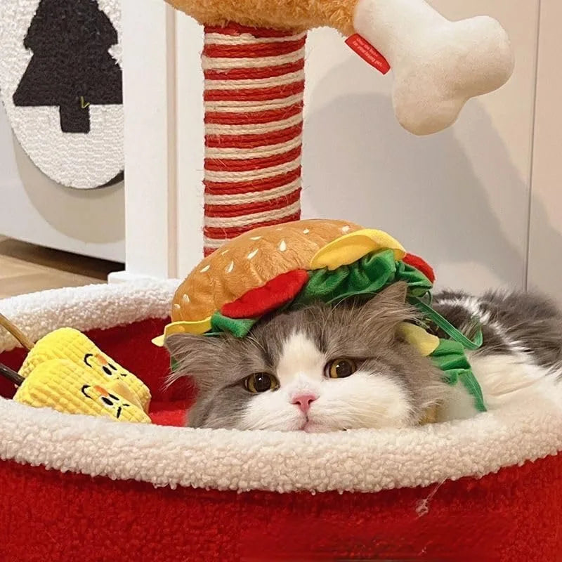 Adorable cat wearing a cat hamburger costume hat while resting in a cozy pet bed