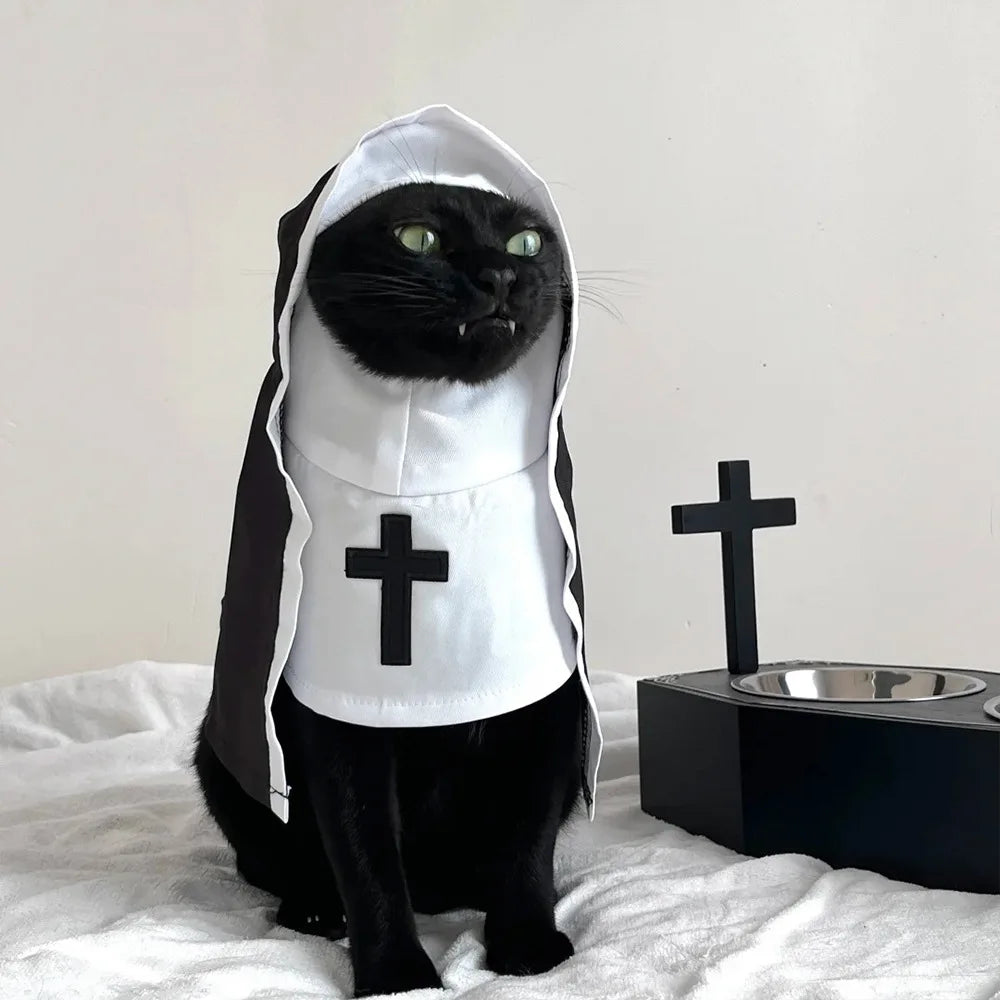 Black cat wearing a cat nun costume for cats and small dogs with a white hood and cross detail