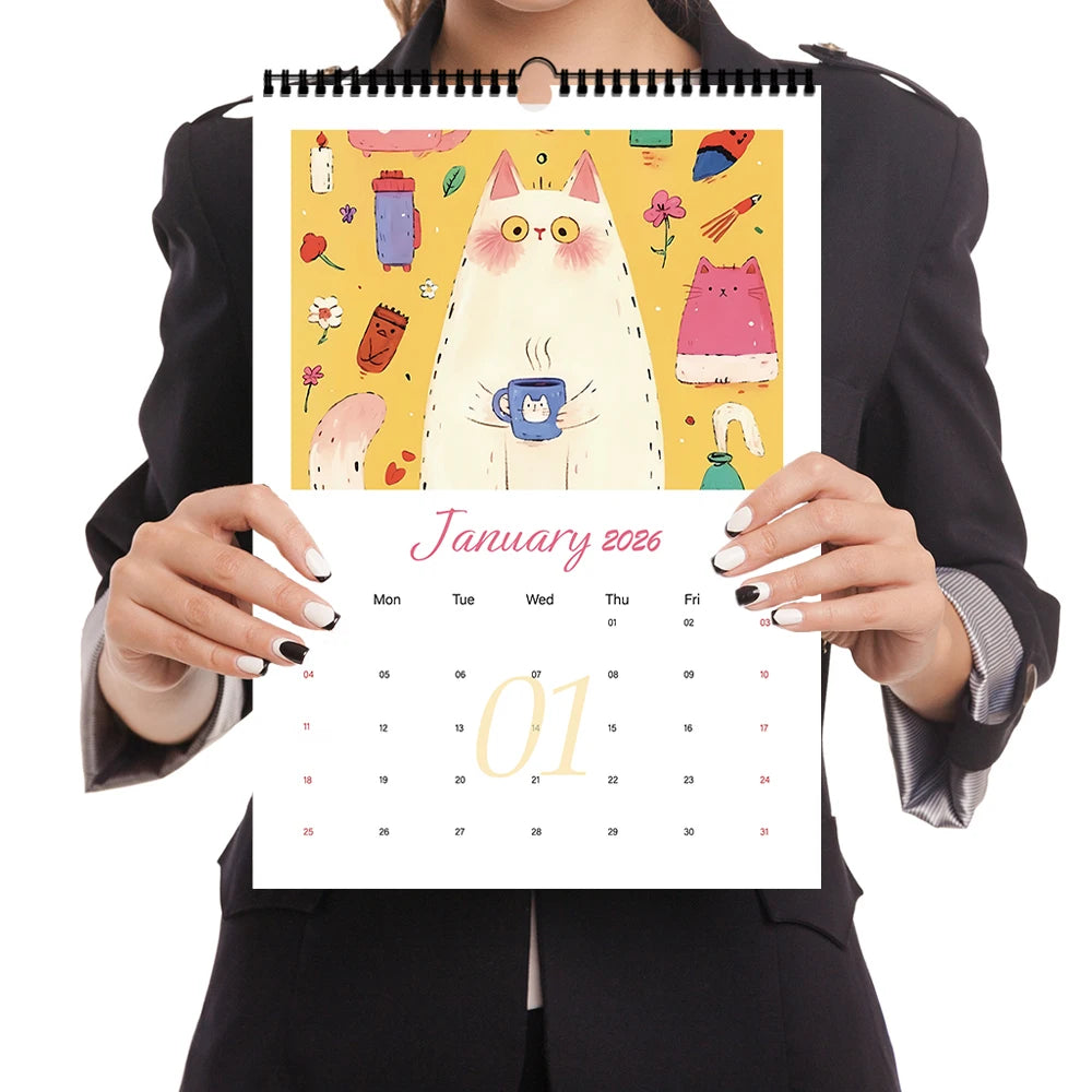 Person holding a colorful cattitude wall calendar 2026 with cat artwork and monthly layout