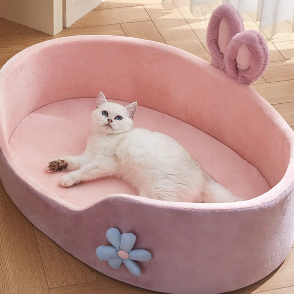 Fluffy cat relaxing in CloudNest Detachable Pet Bed with bunny ears and flower decoration