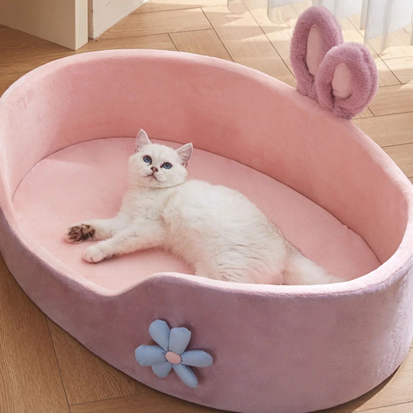 Fluffy cat relaxing in CloudNest Detachable Pet Bed with bunny ears and flower decoration
