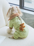 Adorable dog in light green cute dog pajamas with plush accessory for cozy wear