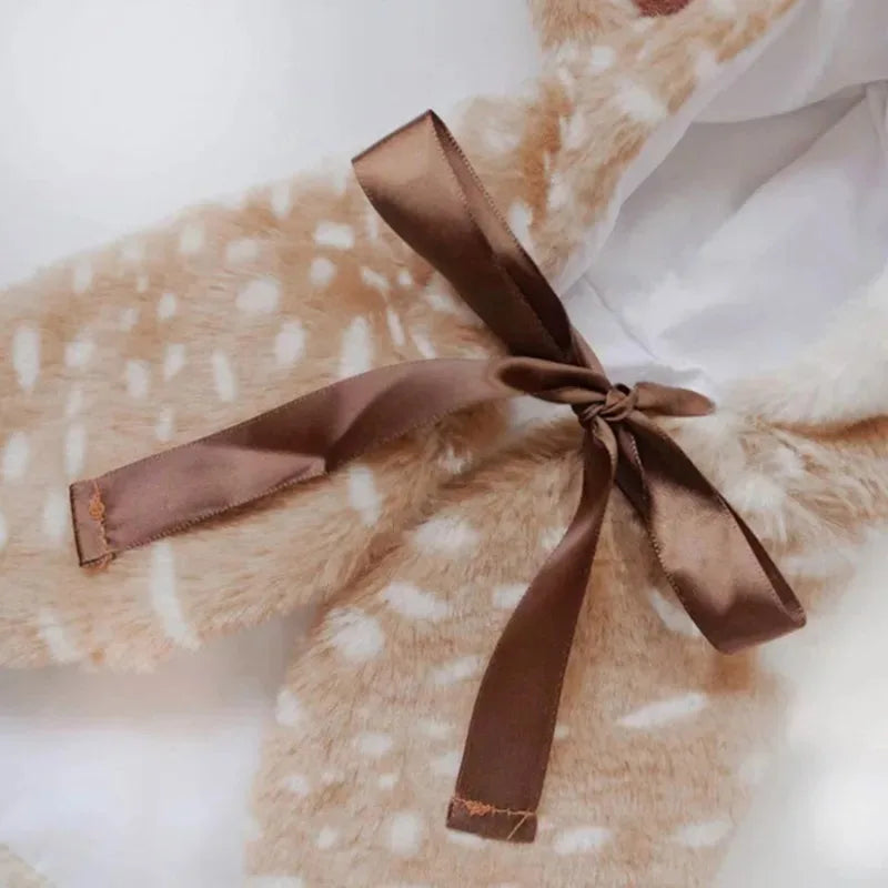 Close-up of a cute dog reindeer costume for puppies featuring a soft texture and a brown satin ribbon