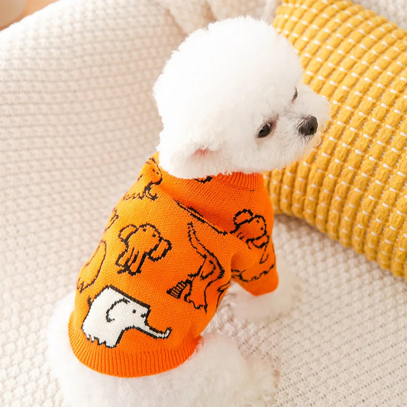 Adorable orange cute knitted dog coat for winter with elephant patterns on a fluffy dog