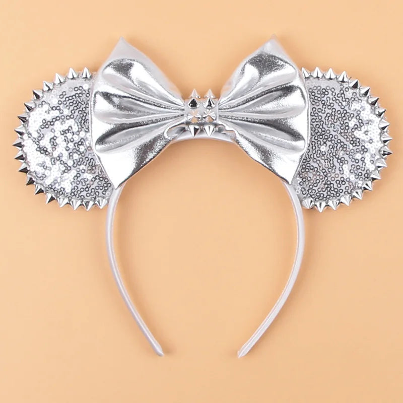 Silver Disney Halloween ear headband with spikes and a bow, perfect for festive fun