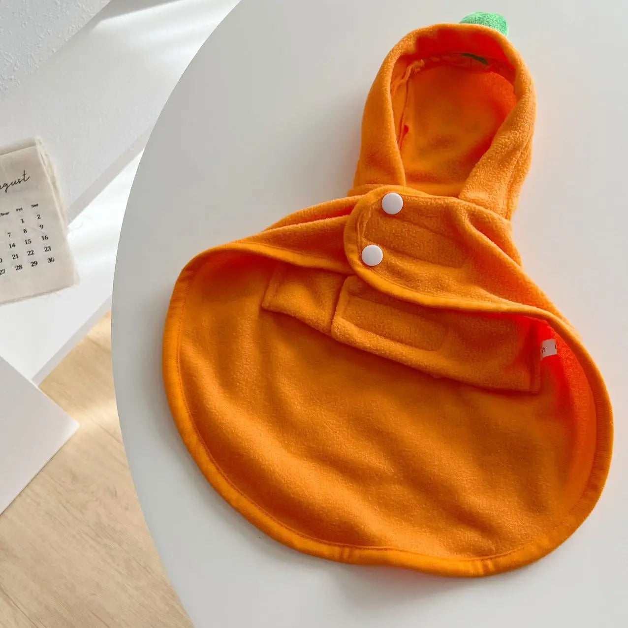 Cute orange dog Halloween ghost cape with a hood and button closure for festive pet wear