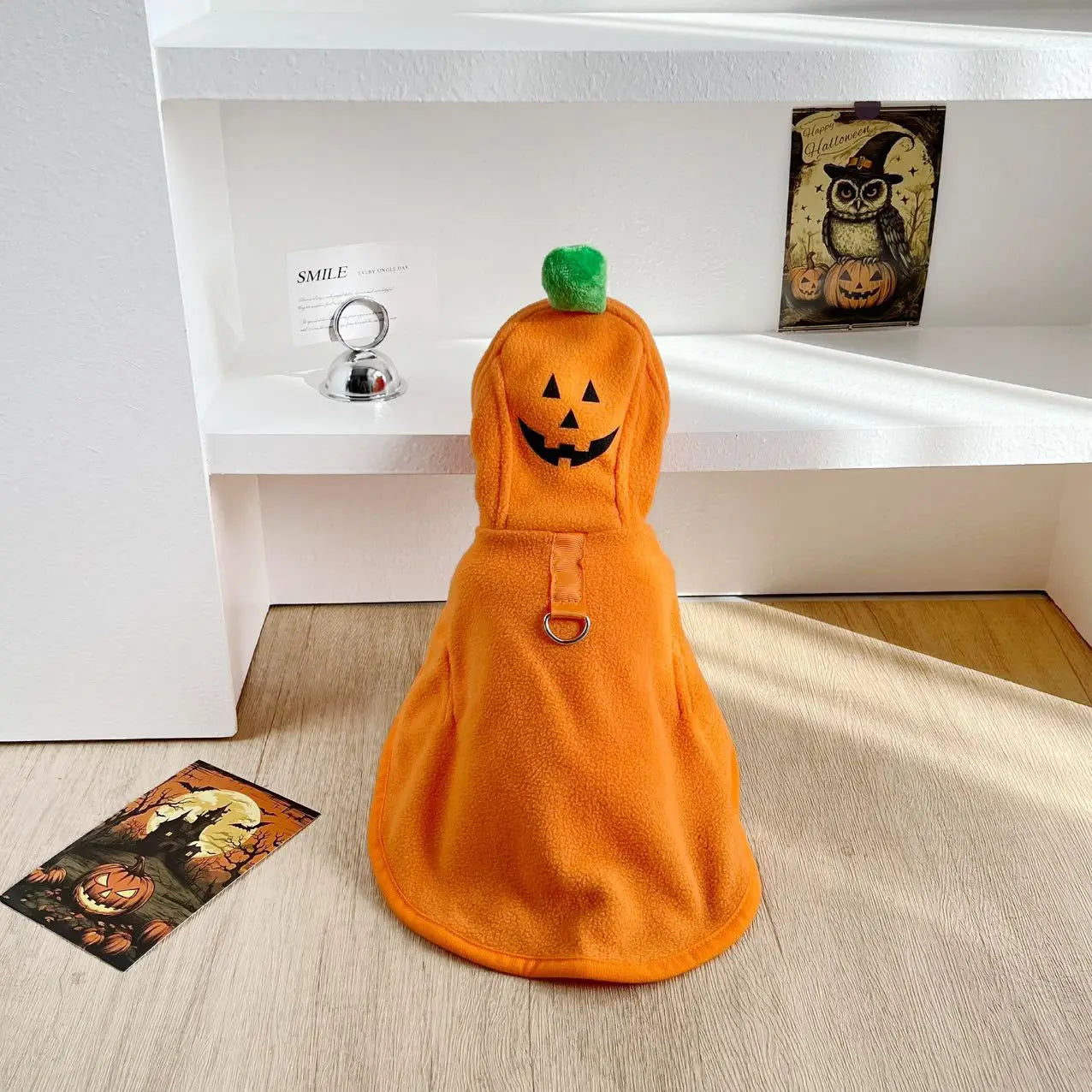 Orange dog Halloween ghost cape with a smiling pumpkin design and a green stem on top