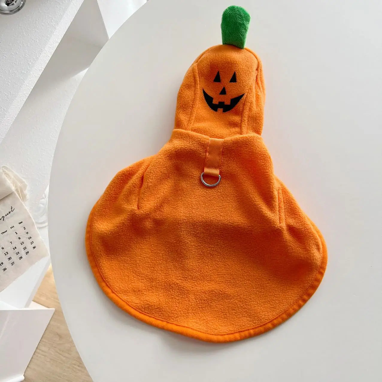 Cozy orange pumpkin costume for dogs featuring a ghost cape for Halloween festivities