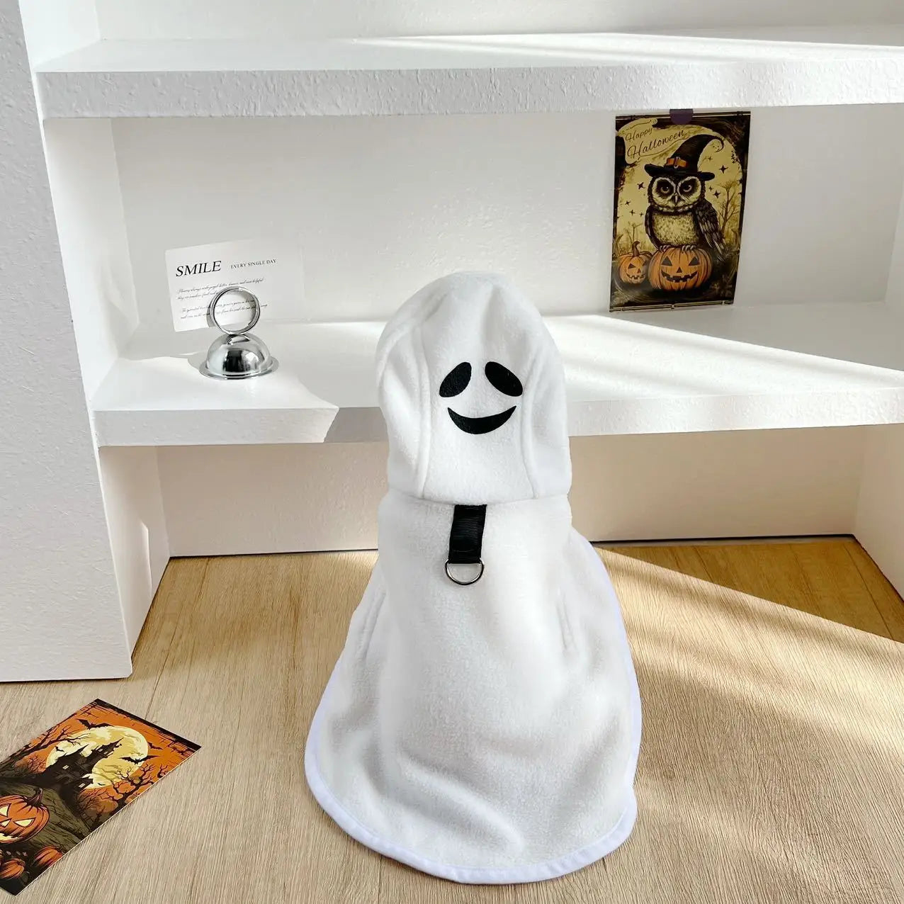 Adorable dog Halloween ghost cape in white with smiling ghost design for festive pet costumes
