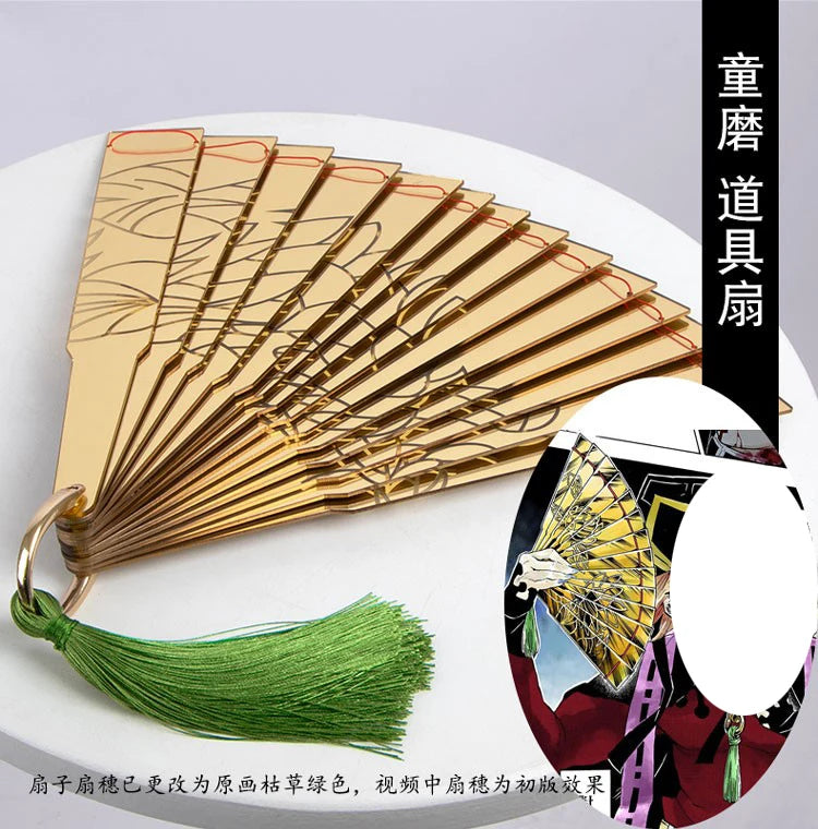 Douma cosplay folding fan with intricate golden design and green tassel for anime fans