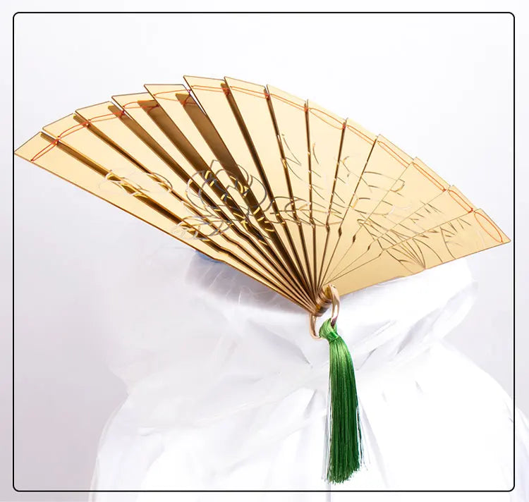 Douma cosplay folding fan in gold with intricate design and green tassel, perfect for costume enthusiasts.