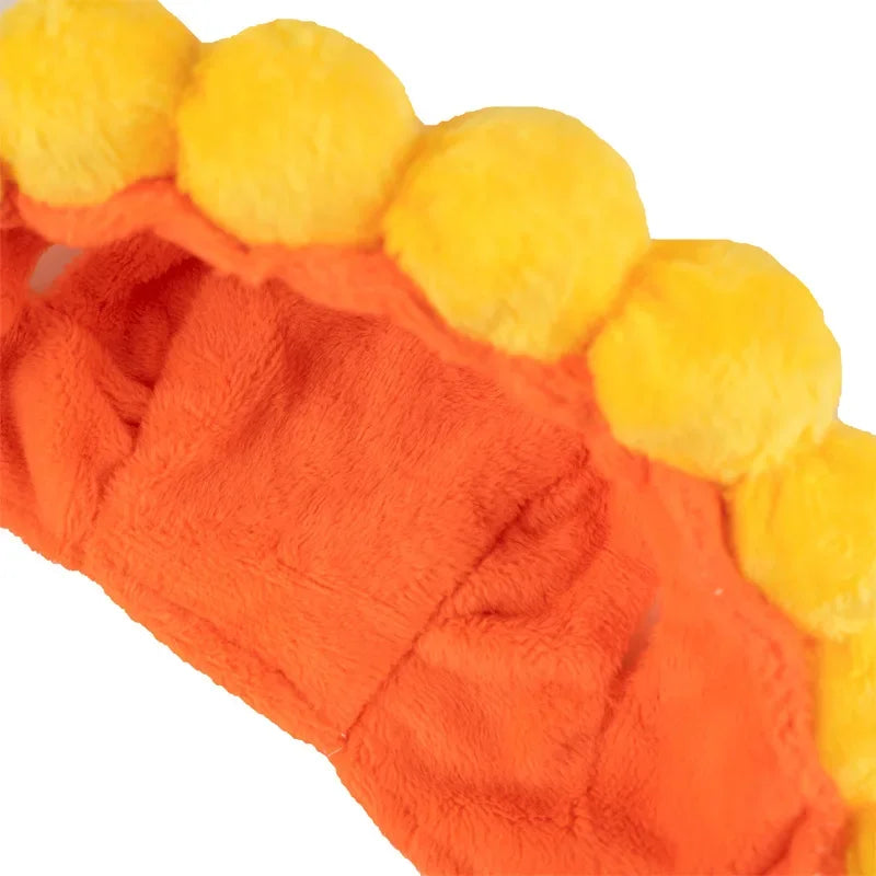 Funny cat hats for costumes featuring bright orange fabric with fluffy yellow pom-poms