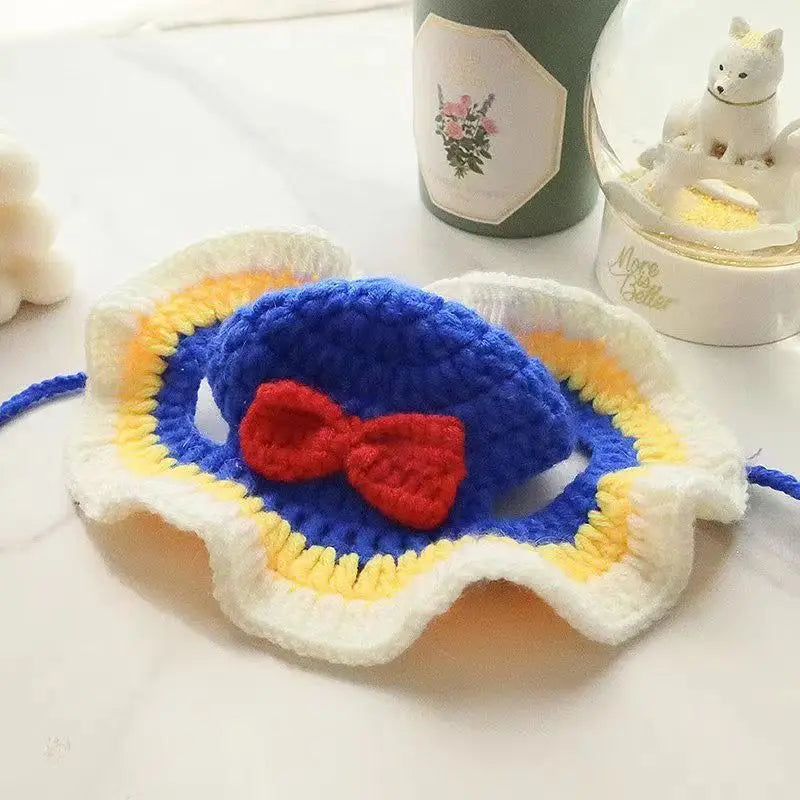 Crochet funny pet hats for cats and dogs with a blue and yellow design and red bow accent