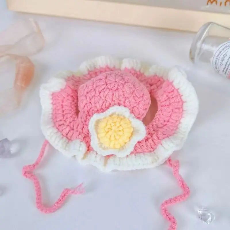 Adorable pink crochet sun hat for pets featuring a flower, perfect as funny pet hats for cats and dogs