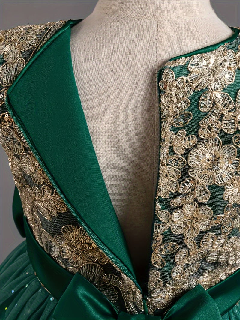 Back view of a girls floral wedding dress with intricate golden embroidery and a teal bow