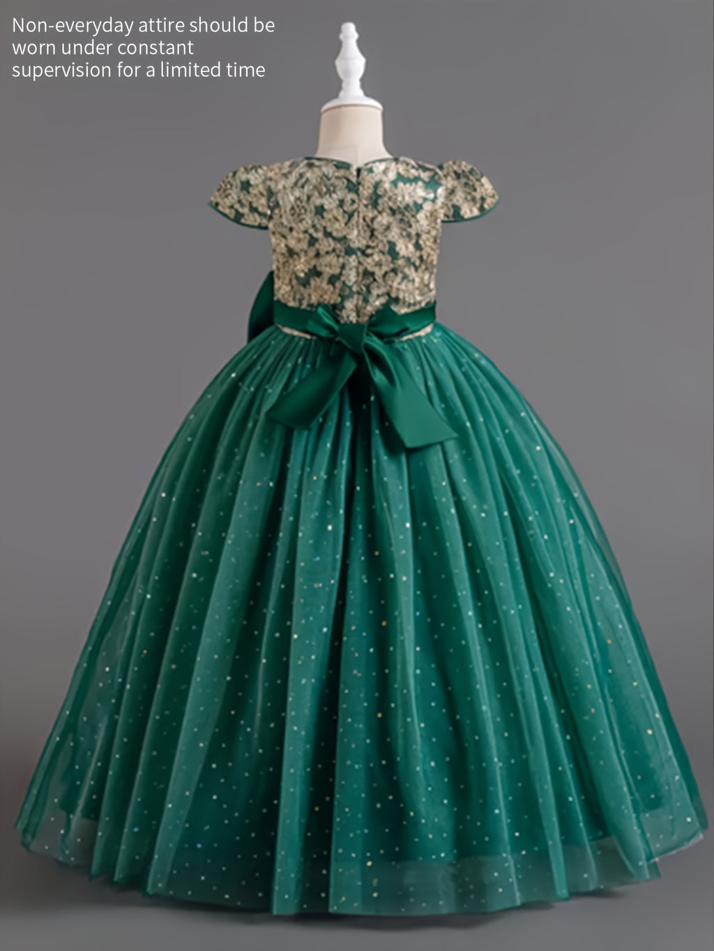 Girls floral wedding dress featuring a floral bodice and a flowing green skirt with sparkles