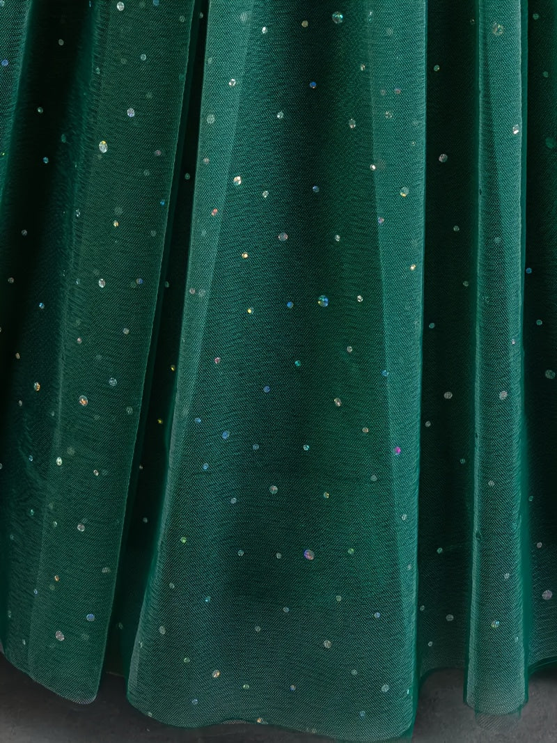 Close-up of a green skirt with floral patterns and sparkly embellishments for a girls floral wedding dress