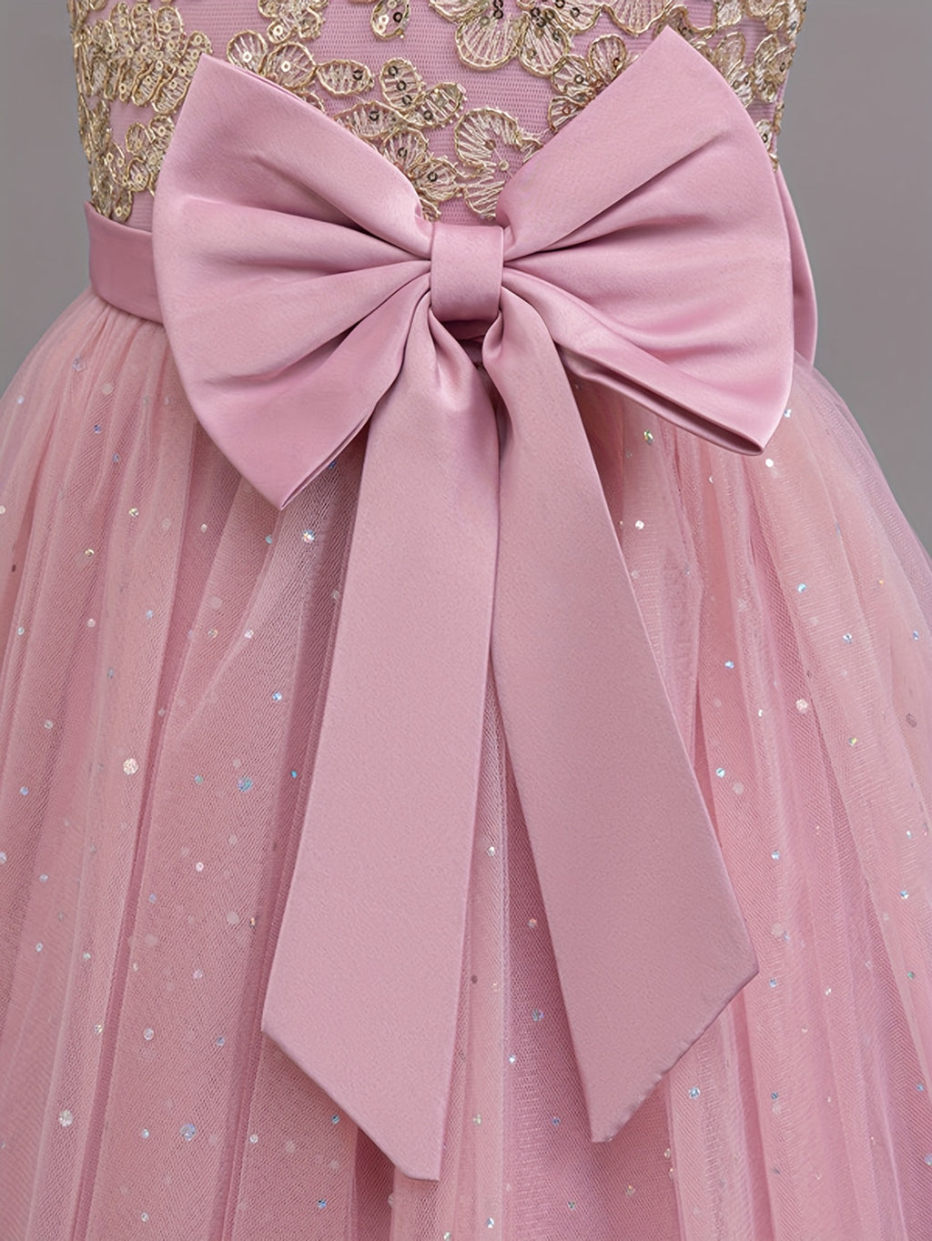 Girls floral wedding dress featuring a stunning pink bow and delicate tulle skirt for special occasions