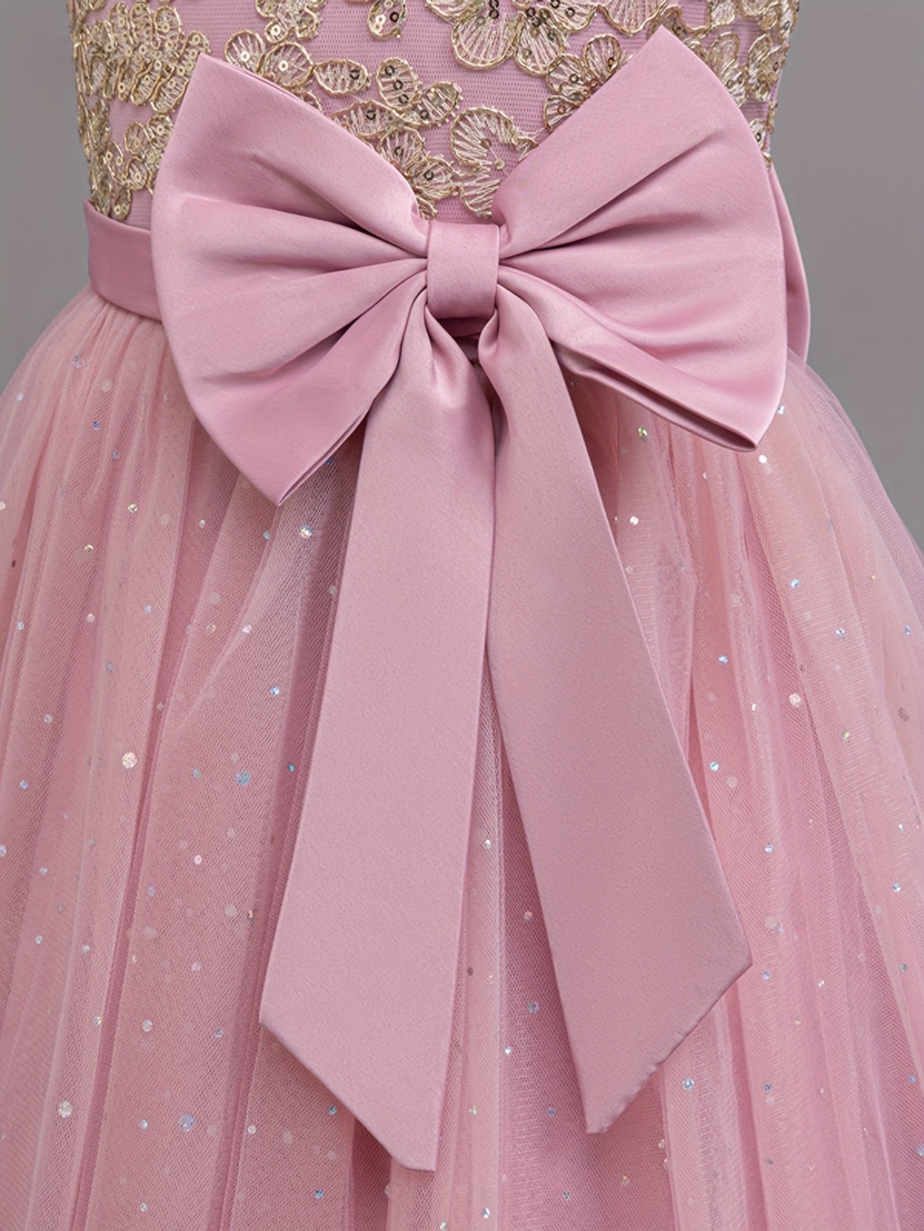 Girls floral wedding dress featuring a stunning pink bow and delicate tulle skirt for special occasions