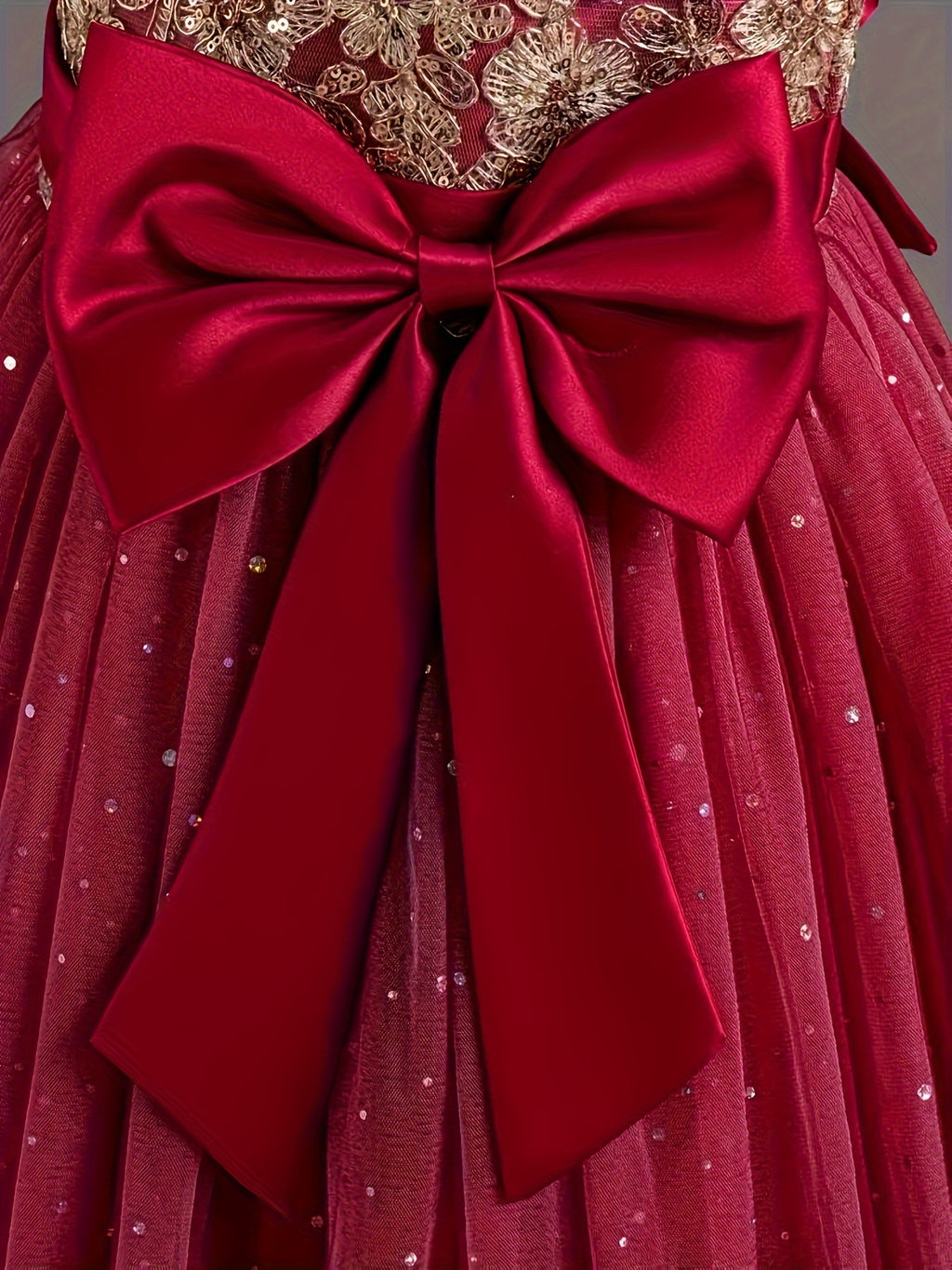 Girls floral wedding dress with a red satin bow and shimmering details for special occasions