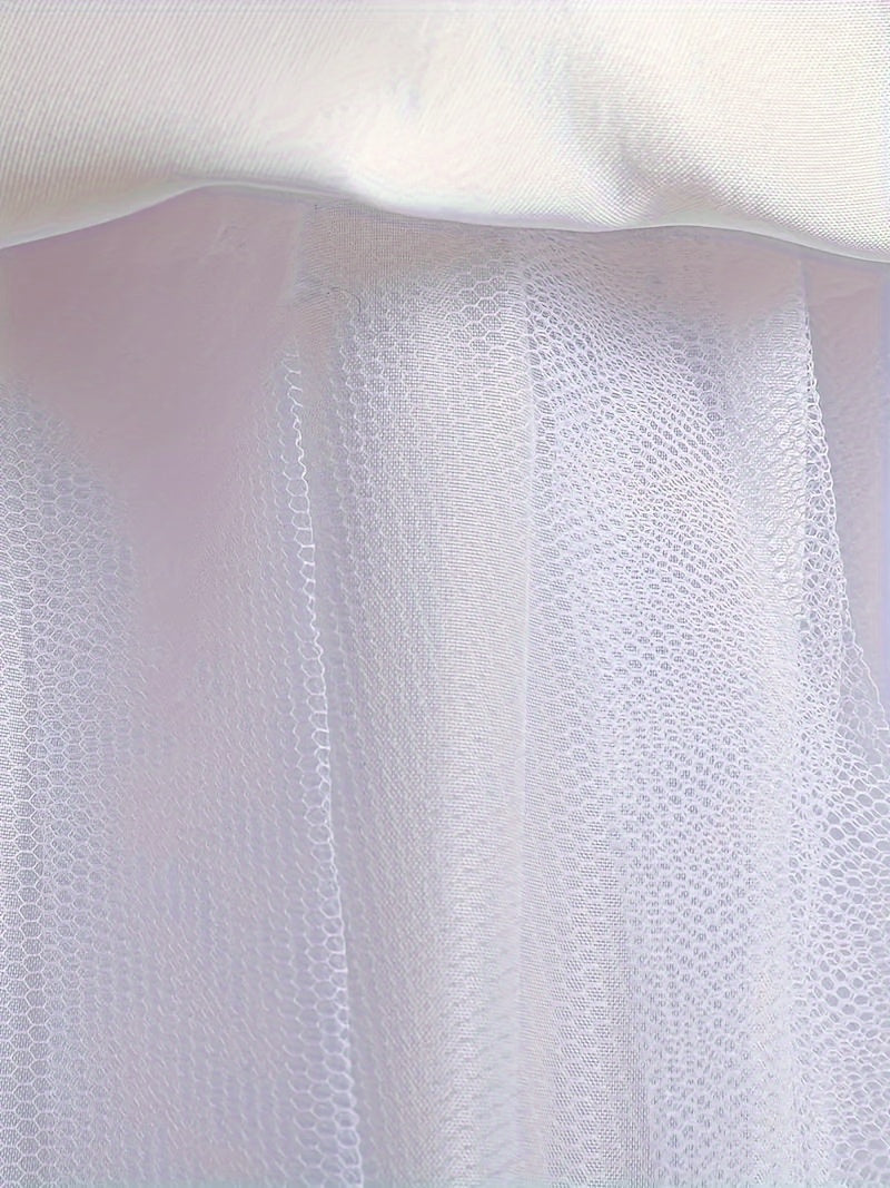 White sheer fabric and tulle layer of a girls floral wedding dress from Zoomies & Co