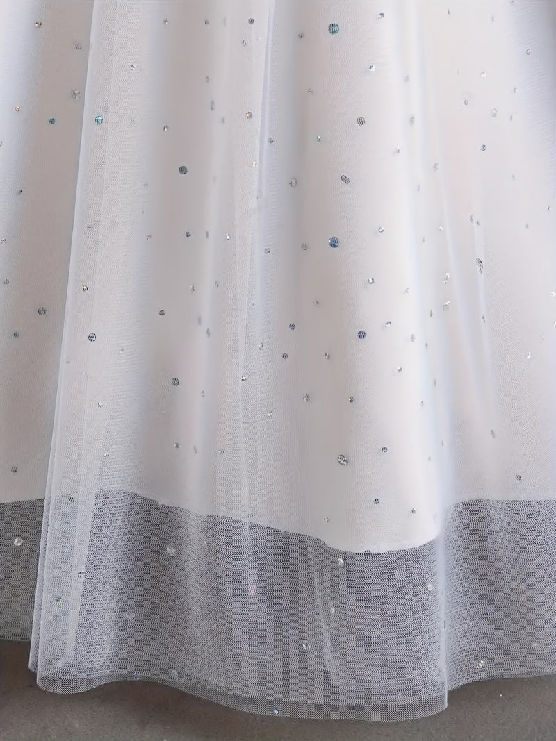 Close-up of a girls floral wedding dress featuring a shimmering tulle overlay with sequins