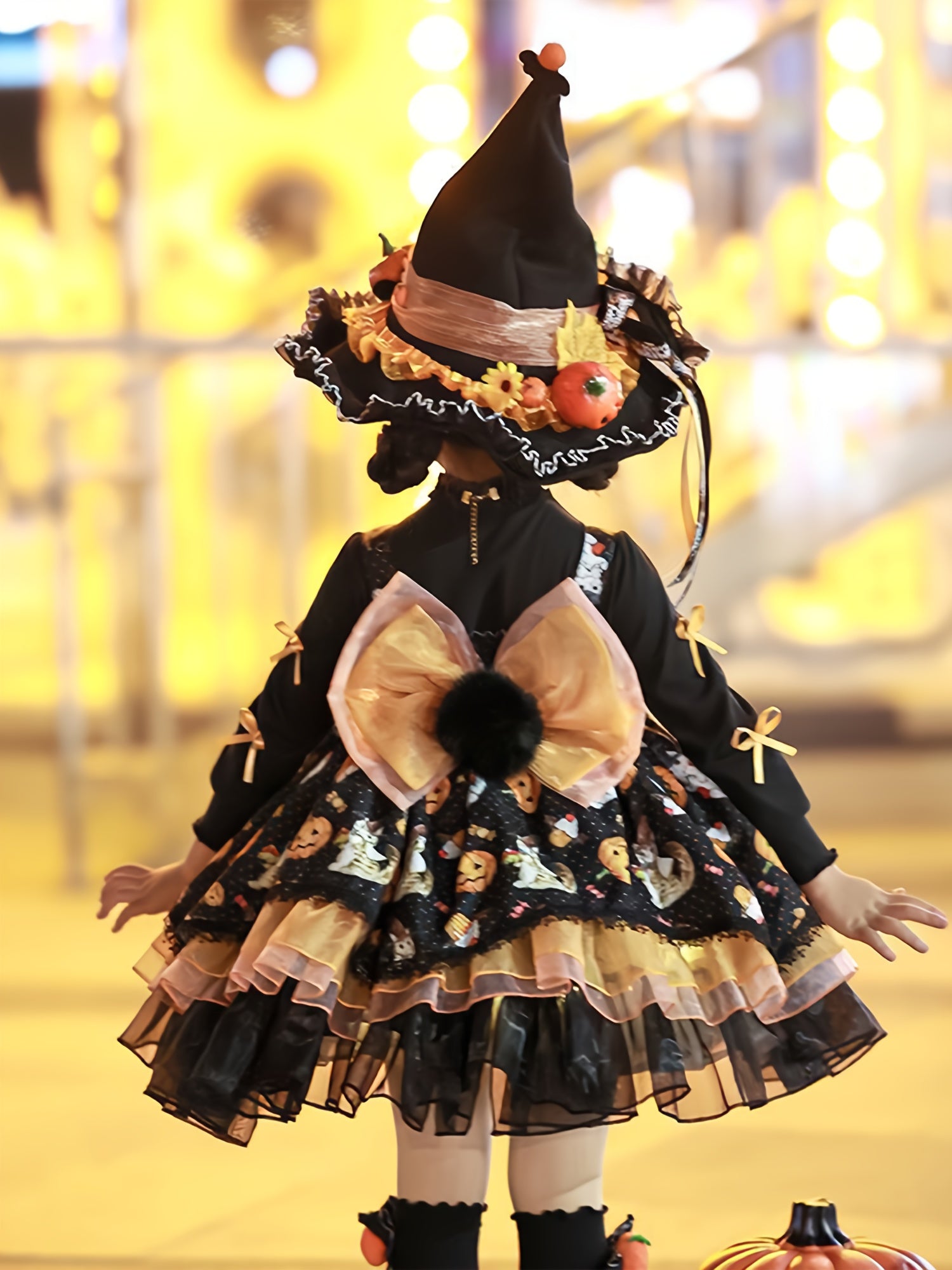 Adorable girls Halloween party dress with witch hat and festive pumpkin details for spooky celebrations
