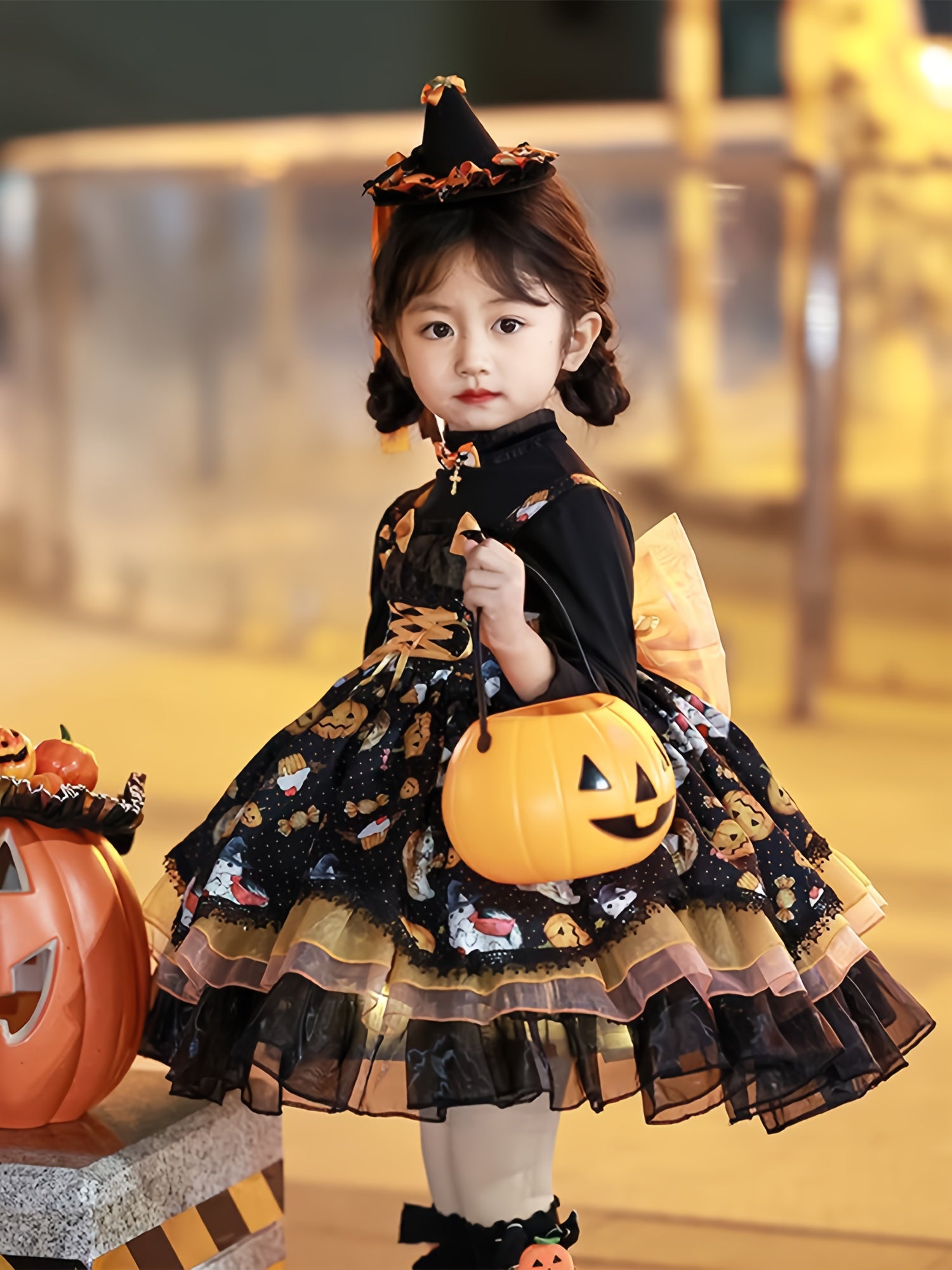 Adorable girls Halloween party dress with pumpkin bucket and witch hat, perfect for festive celebrations