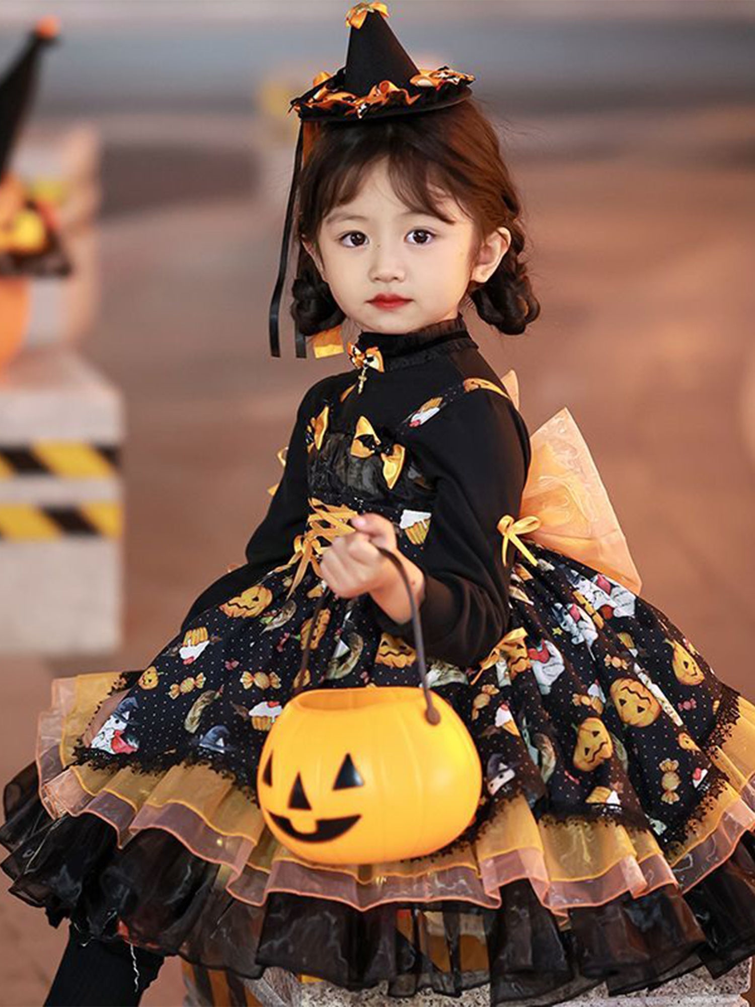 Adorable girls Halloween party dress with pumpkin print and matching hat for festive celebrations