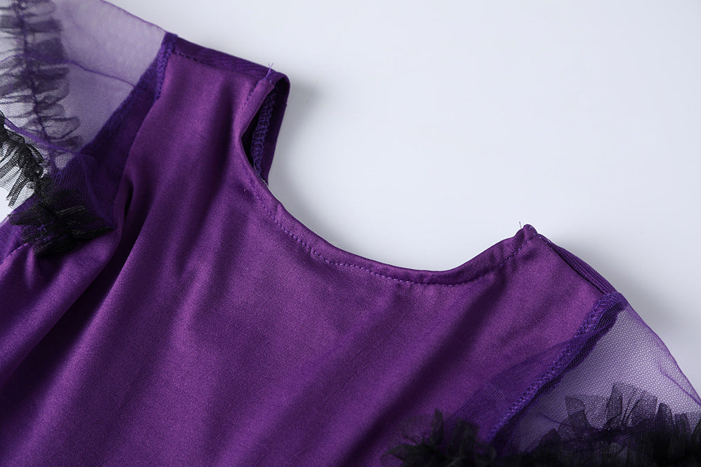 Close-up of girls purple bat costume featuring soft fabric and sheer black accents