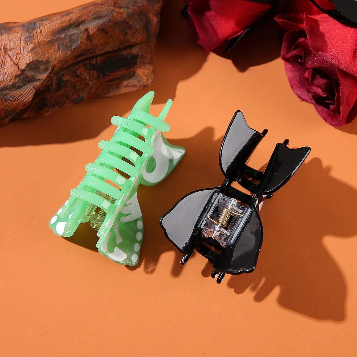 Halloween acrylic skull hair accessory featuring green and black designs for festive hairstyles