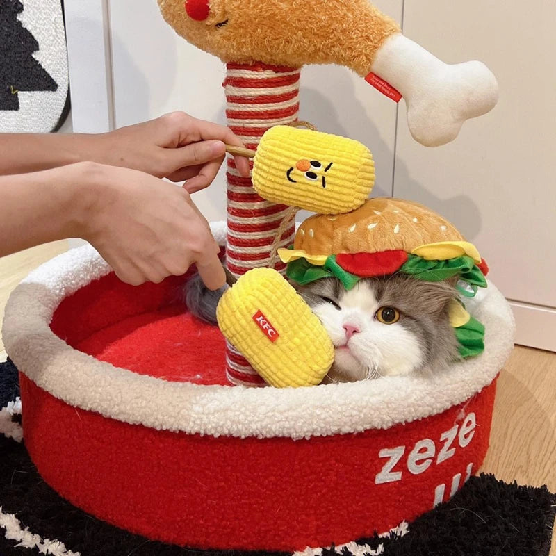 Cute cat wearing a Halloween dog burger costume with playful toys in a cozy pet bed
