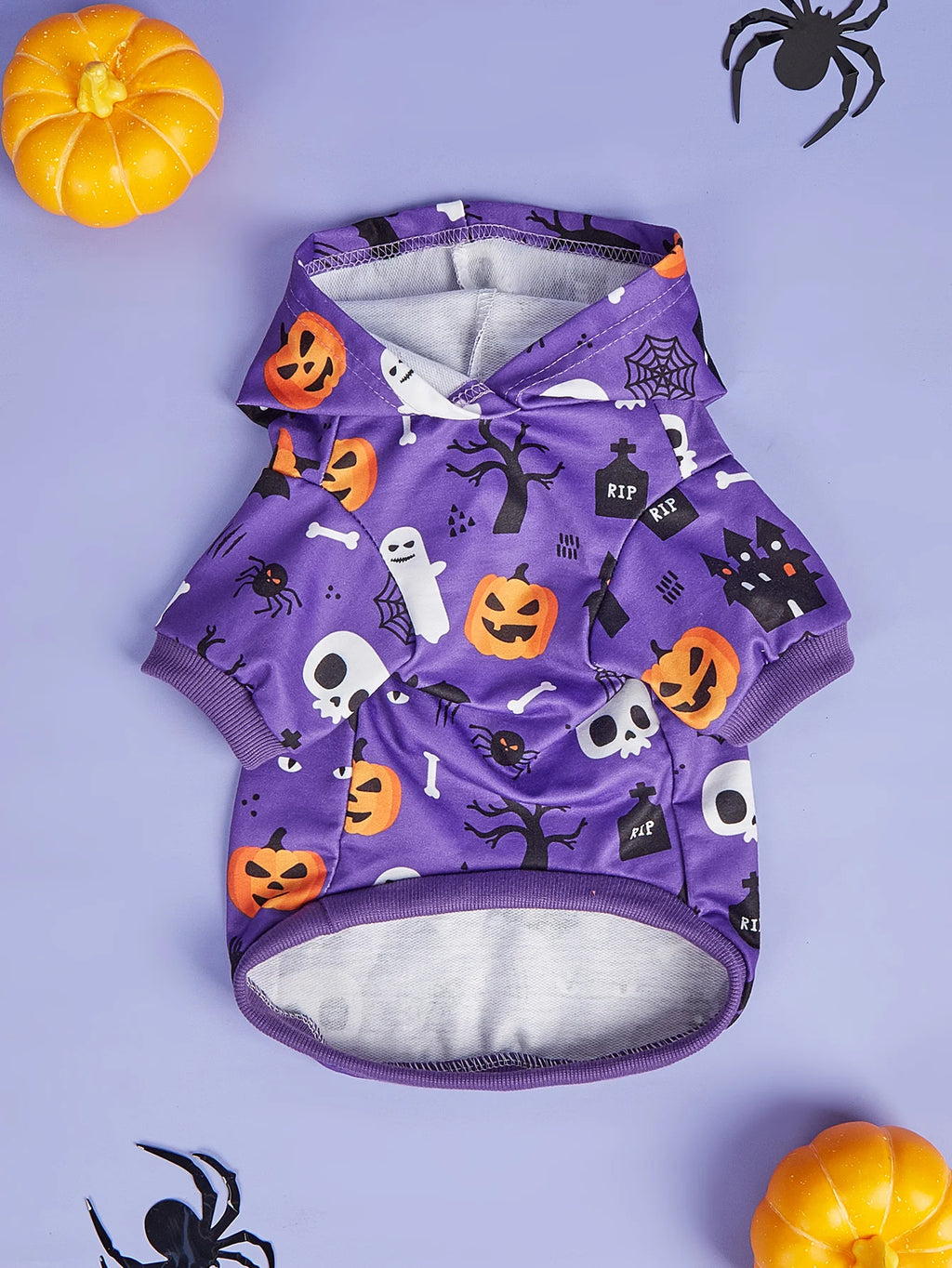 Purple Halloween dog costume for small dogs featuring spooky skulls, pumpkins, and ghosts